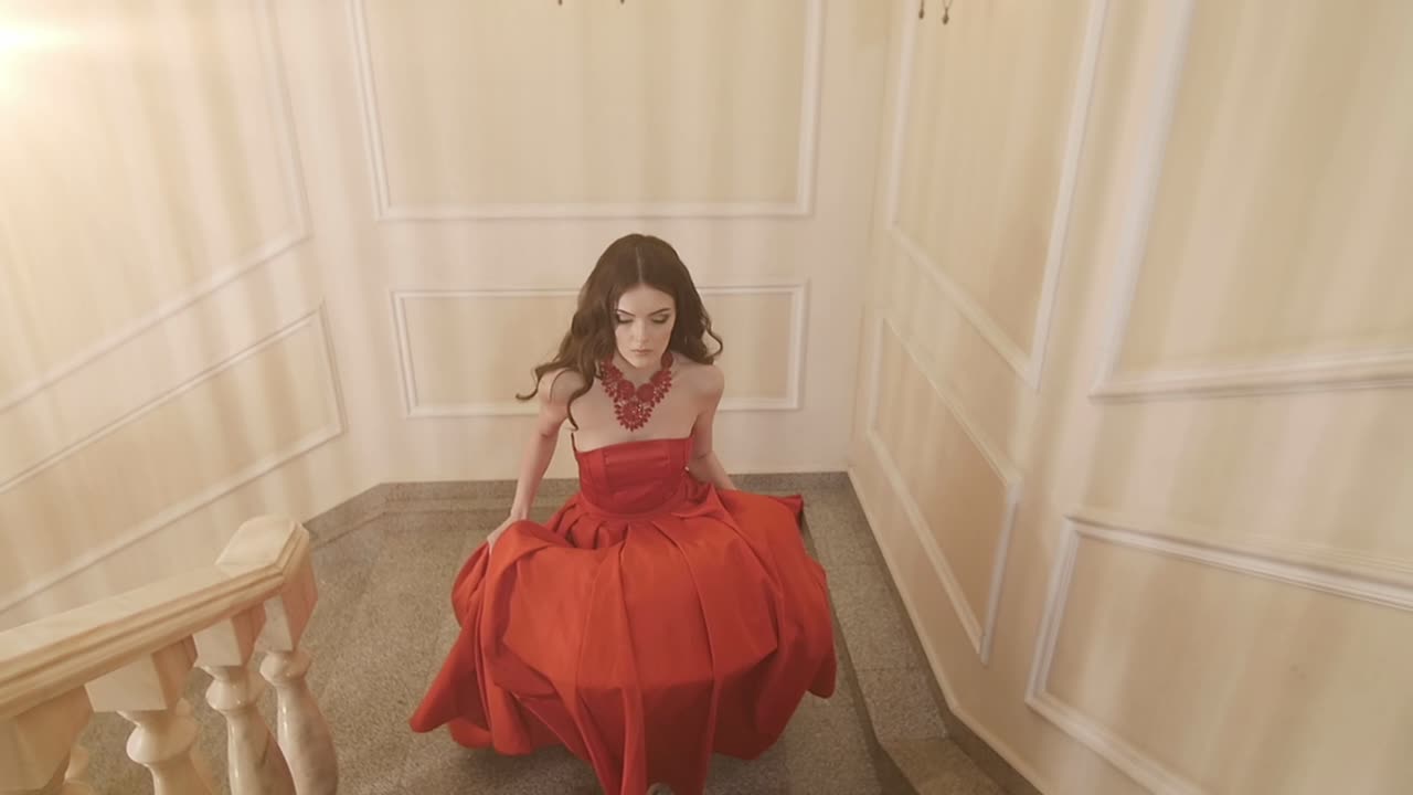 Woman in Red Gown on Grand Staircase