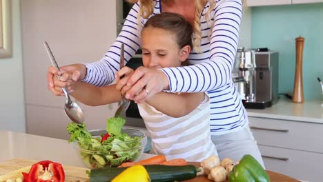 mother and daughter making a salad