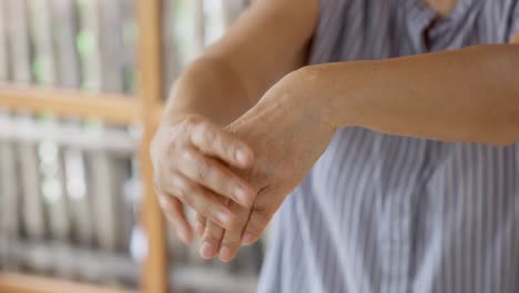 close up of old woman stretching her forearms