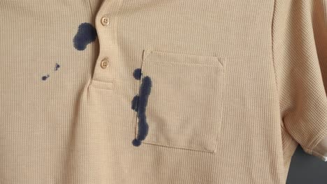 a tan shirt with ink stains