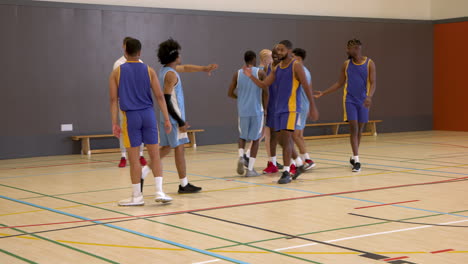 basketball players in gym shaking hands, building team spirit and camaraderie