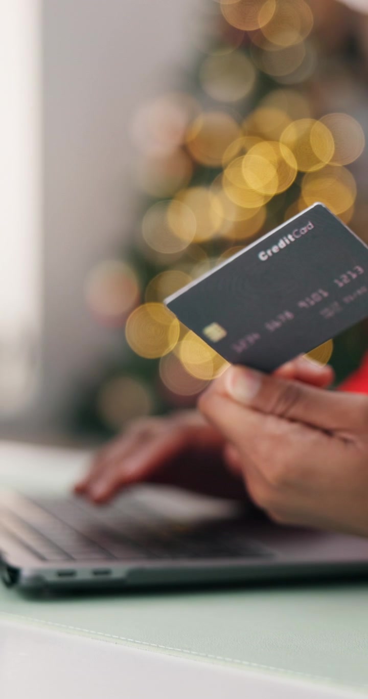 Person Shopping Online with Credit Card During Christmas Season