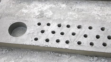 perforated concrete slab with uniform holes, ready for installation or transport