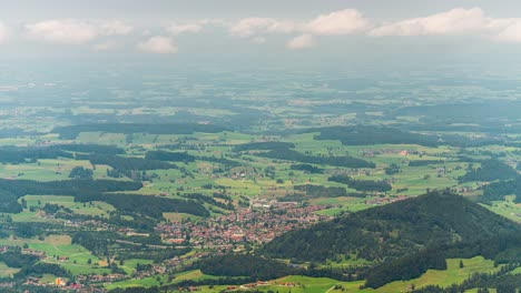 this timelapse video captures a bird’s-eye view of the bavarian plains of allgäu, germany. green fields, dense forests, and small villages blend together, stretching endlessly under soft clouds.