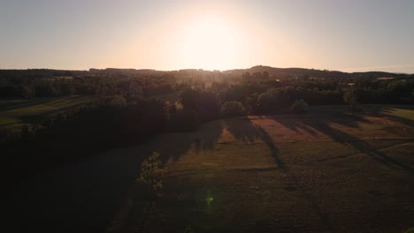 As-the-day-draws-to-a-close,-the-peaceful-calm-of-a-rural-village-is-bathed-in-the-warm-hues-of-the-setting-sun,-creating-a-serene-and-idyllic-scene-that-feels-like-stepping-back-in-time