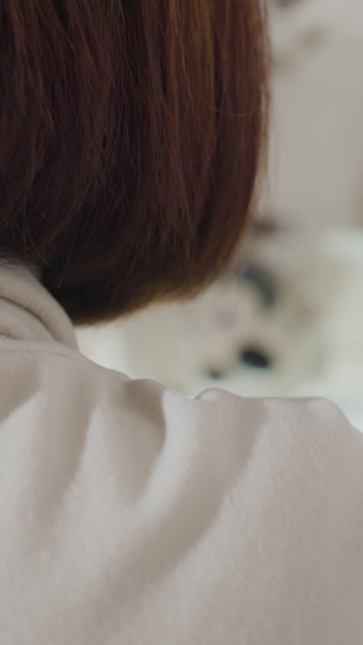 Closeup seamstress sewing grey garment machine, hands guiding hem for precise finish in bright studio, bob haircut framing neck, meticulous tailoring, quality check, artisanal atmosphere