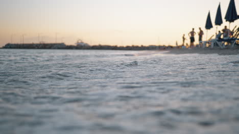 Sea-waves-washing-the-shore-of-resort-at-sunset