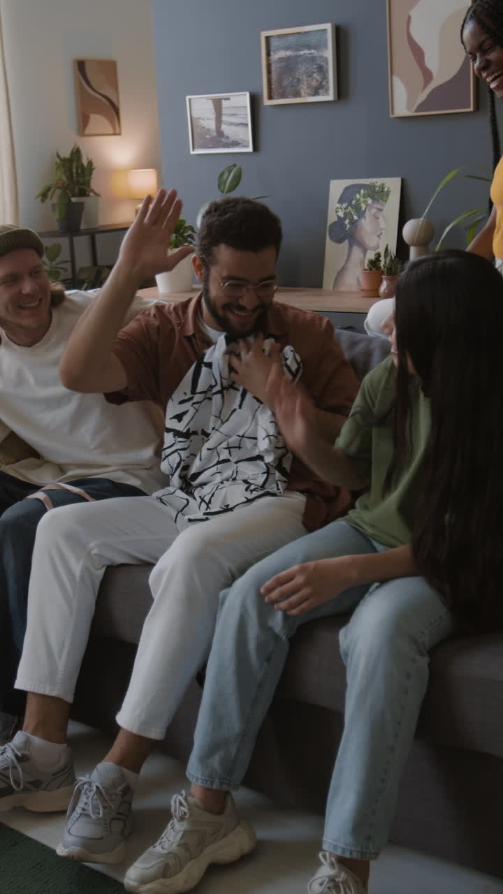 Friends showing a new gift in a living room