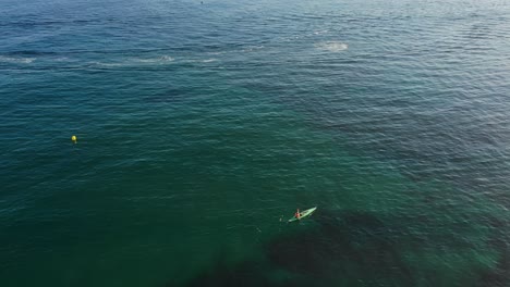 drone shot of a jetski and a paddle board in spain