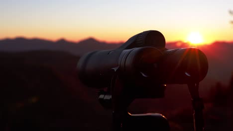 epic sunset pan with binoculars and mountain wilderness