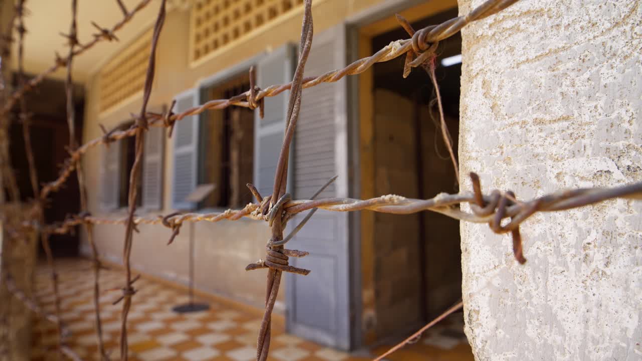 Close-up of rusted wire outside torture jail cell block building in Phnom Penh,