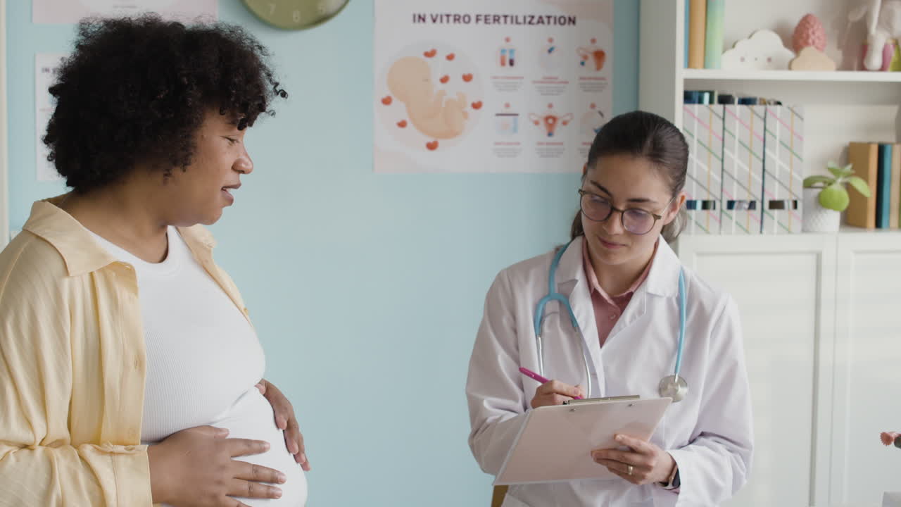 Pregnant woman consulting with her doctor