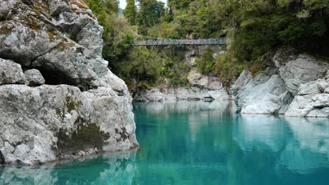 capture the majesty of hokitika gorge with a mesmerising long shot of a suspension bridge over it