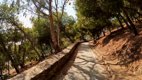 Walking-descent-from-Gibralfaro-Castle,-Malaga,-Spain