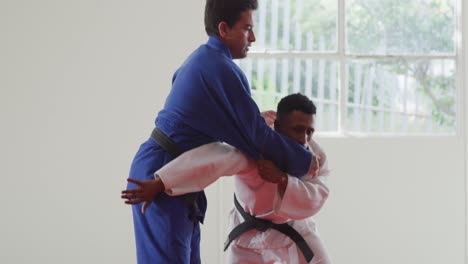 judokas training by doing a randori on the judo mat