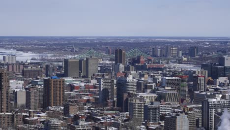 wide shot of montreal urban city buildings with jacques cartier bridge in background