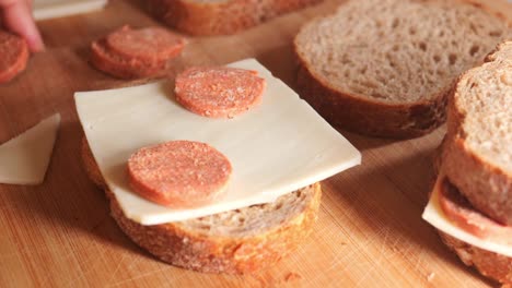 making a delicious salami and cheese sandwich