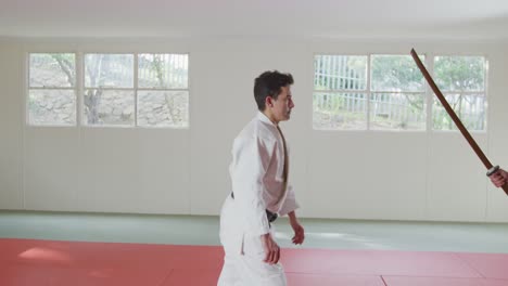 judokas training with a wooden saber