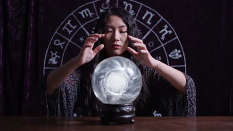 woman fortune teller with crystal ball and astrological symbols