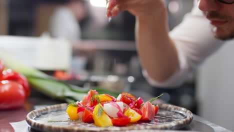 restaurant chef salting fresh salad