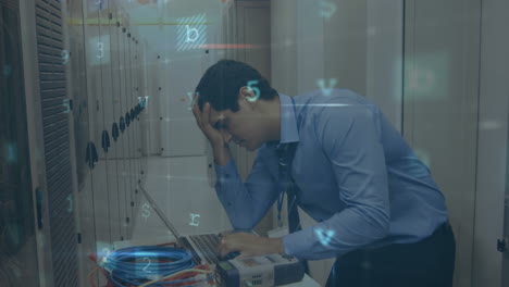 hombre preocupado en una sala de servidores de computadora usando una computadora portátil