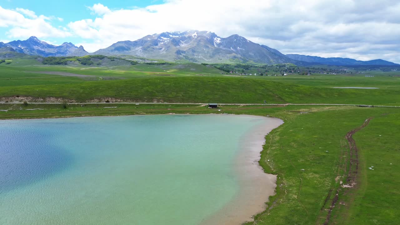 Aerial closeup of Vrazje jezero vivid blue green hue glacial lake in Durmitor National Park on Jezerska plateau