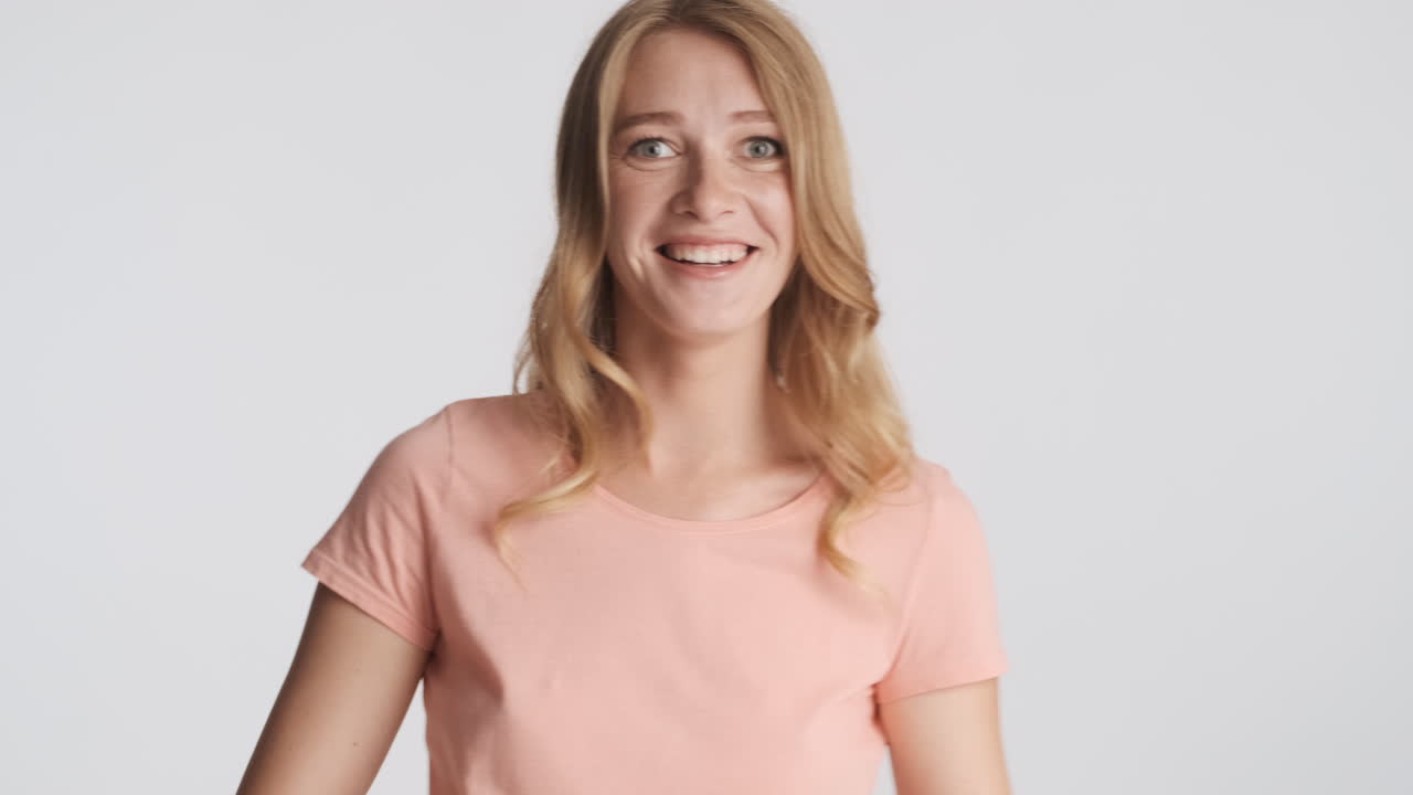 Caucasian woman laughing on camera.