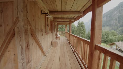 walking on wooden balcony enjoying majestic green mountains in foggy day