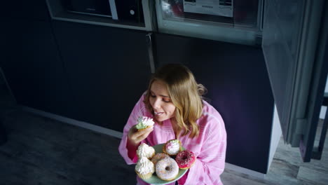 sweet woman eating cake with appetite. eating woman enjoy cupcake