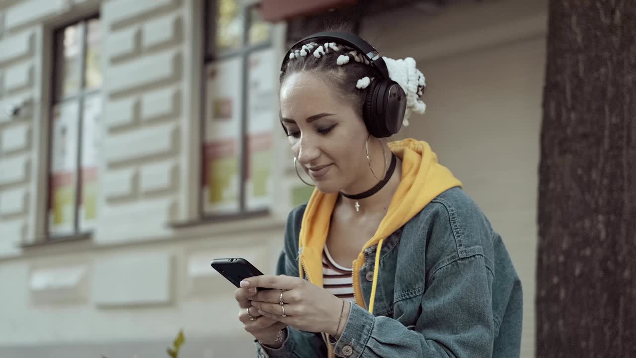 Joyful young woman listening to music wear earphone. Social network concept