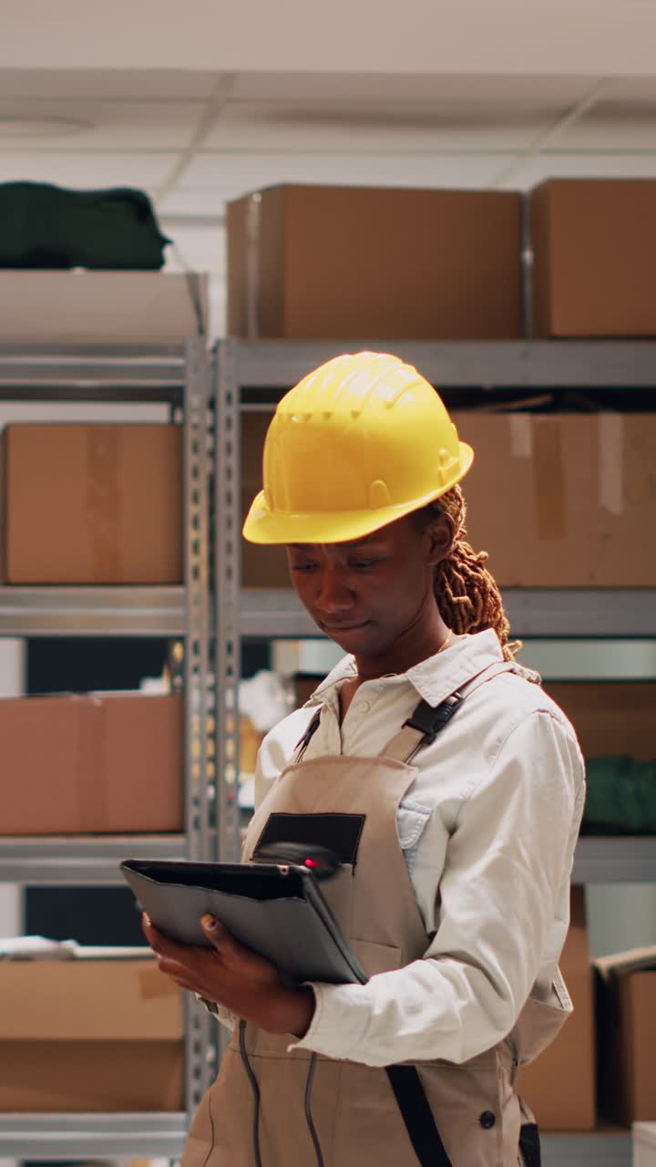 Vertical video: Depot employee pointing scanner at cardboard boxes