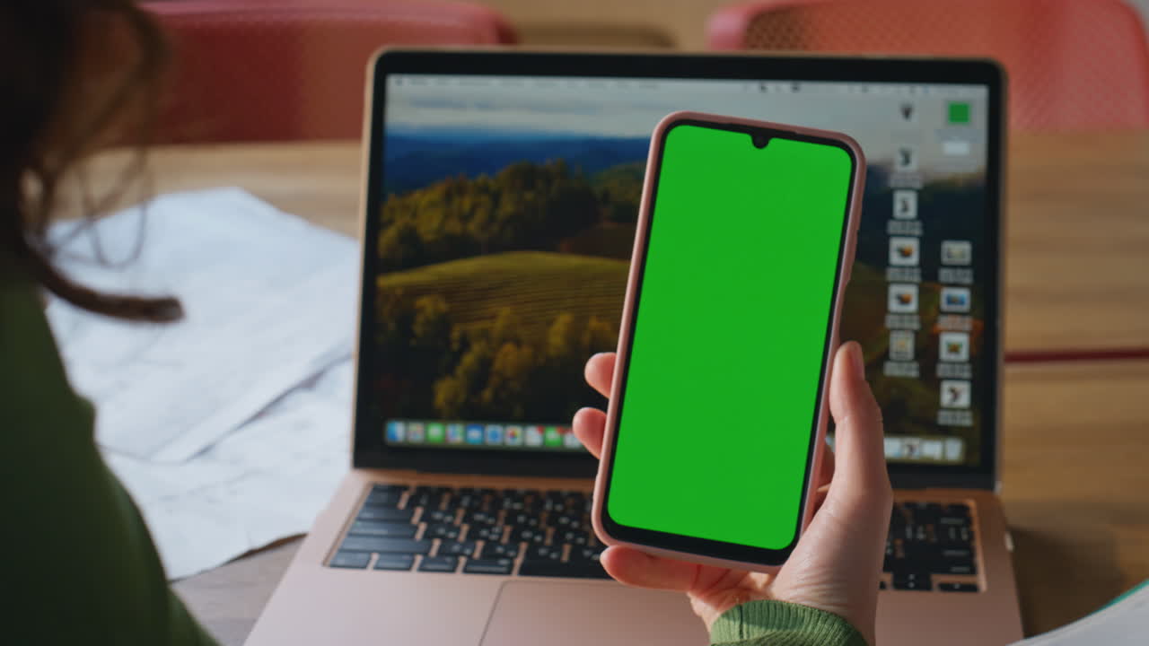 Freelancer hand scrolling greenscreen mobile phone home closeup. Woman swiping
