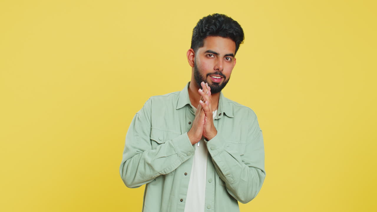 Sneaky cunning Indian young man thinking over devious villain idea, cheats, jokes, pranks, evil plan