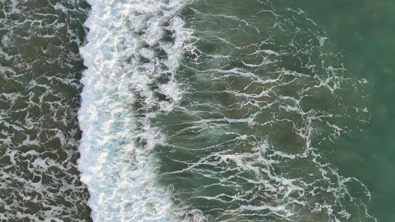 The ocean from above, Waves Breaking on the Beach. Portugal, Algarve. Ariel Drone shot.