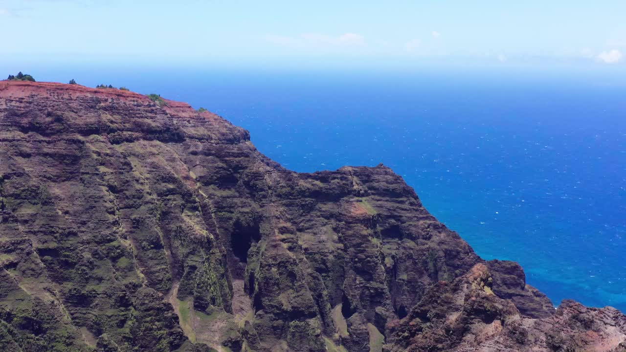 Cinematic aerial drone shot in 4K tilt down of the lush Na Pali Coast in Kauai, Hawaii