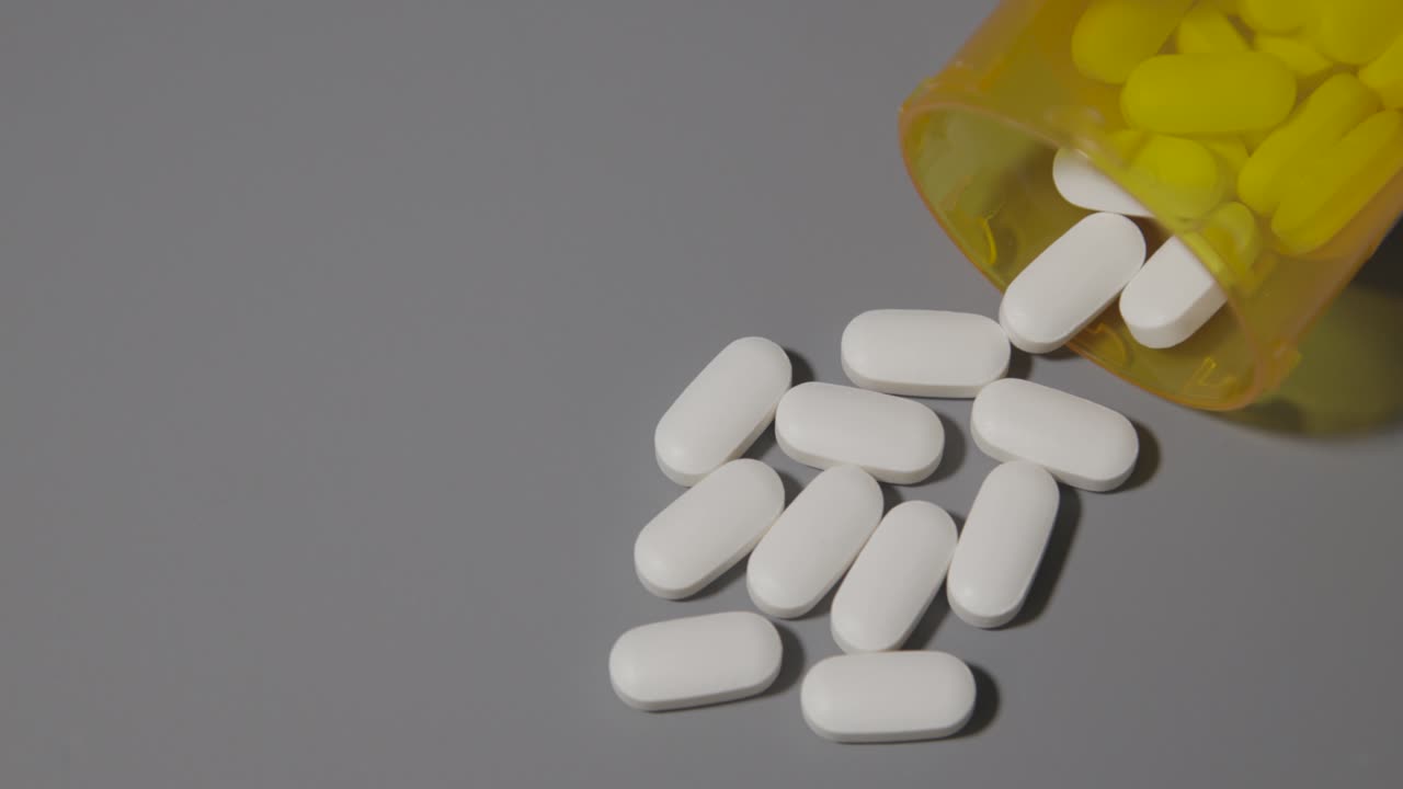 prescription pills pill bottle on neutral gray table