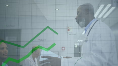 male doctor holding stethoscope reviewing data on tablet with hospital team, showing animated graph