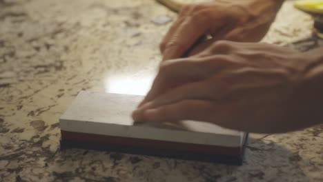 Hands-Sharpening-The-Knife-Manually---close-up