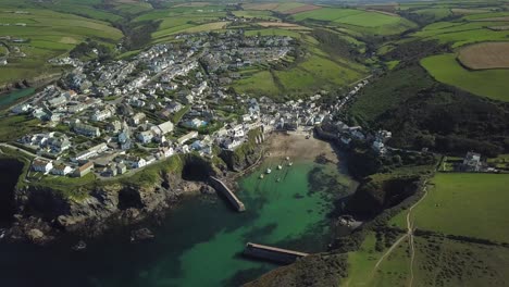 the quiet port isaac village in england by the sea -aerial tilt down