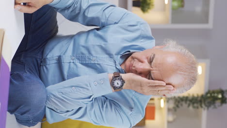 vertical video of the old man about to leave takes off his ring.