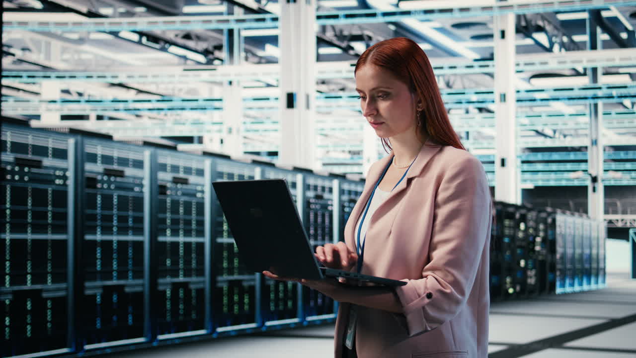 Female IT Engineer Working on Laptop in Modern Data Center