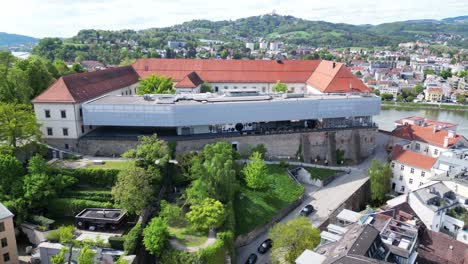 schlossmuseum at linz castle with danube river in the background in linz, austria. - aerial shot