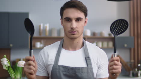 chef man ready cooking at home kitchen. male cook standing at modern apartment