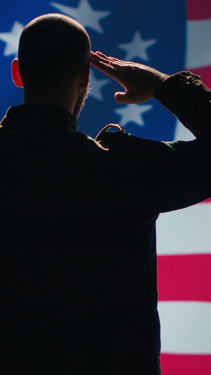 Vertical video United States of America veteran honoring his country, saluting flag
