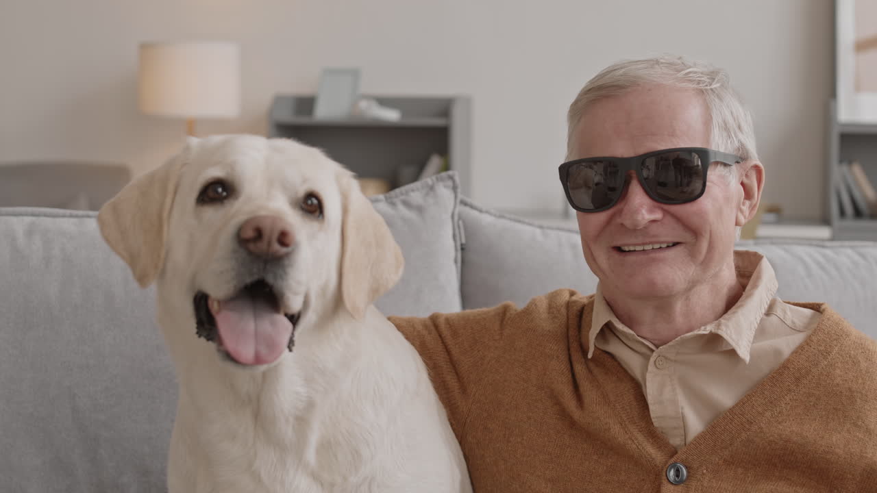 Portrait of Blind Senior Man and His Labrador Retriever Dog