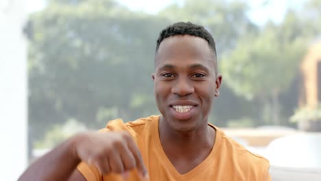feliz hombre afroamericano haciendo una videollamada, hablando y gesticulando en casa, cámara lenta