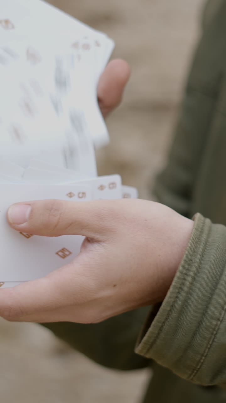 Close-up of Hands Shuffling Playing Cards