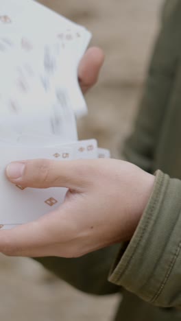 close-up of hands shuffling playing cards