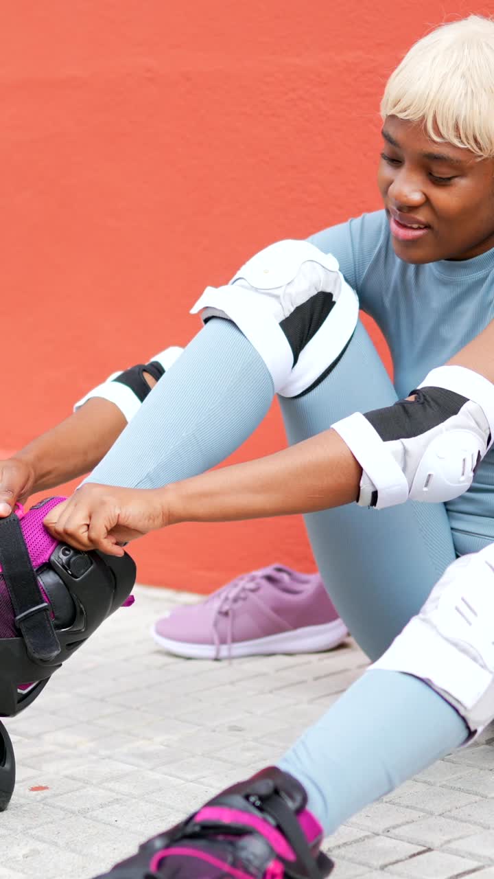 Woman putting on roller skates with protective gear