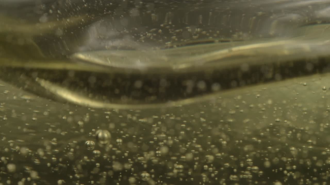Abstract of golden bubbles slowly floating in liquid